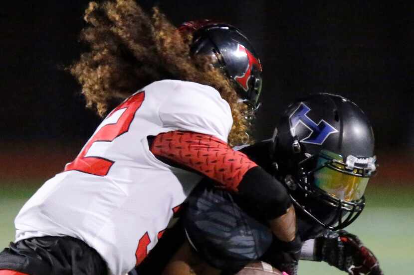 FILE - Euless Trinity free safety Sebastian Tauaalo (32) brings down Hebron wide receiver...