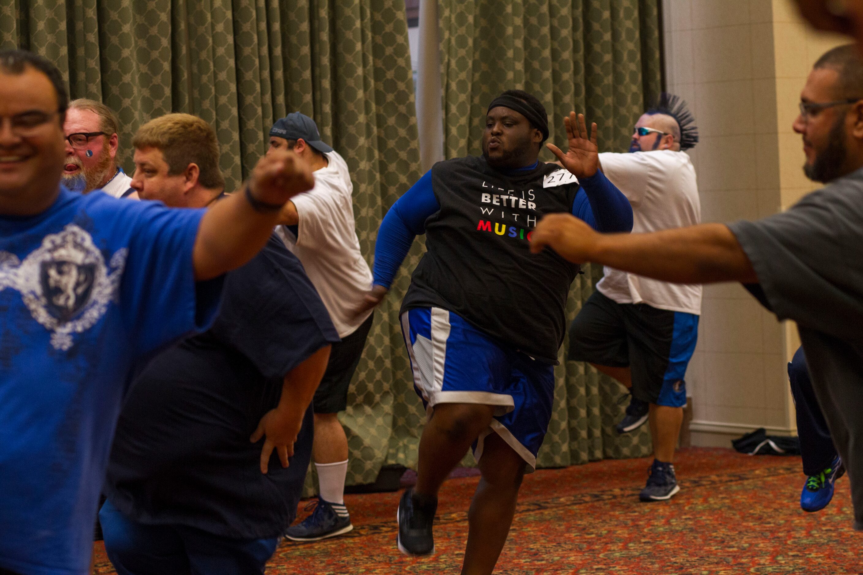 Major Attaway, center, of Fort Worth, practices dance moves during The Mavs ManiAACs...