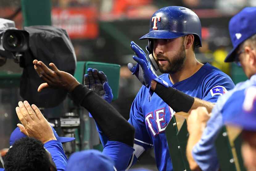 ANAHEIM, CA - SEPTEMBER 12:  Joey Gallo #13 of the Texas Rangers is congratulated in the...