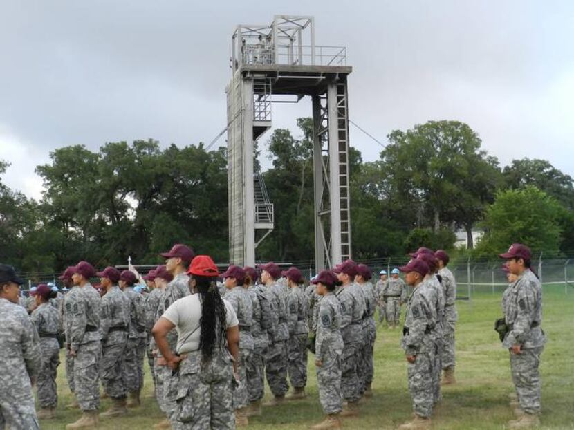 
JROTC students muster in front of a training obstacle at Camp Bullis during a week-long...