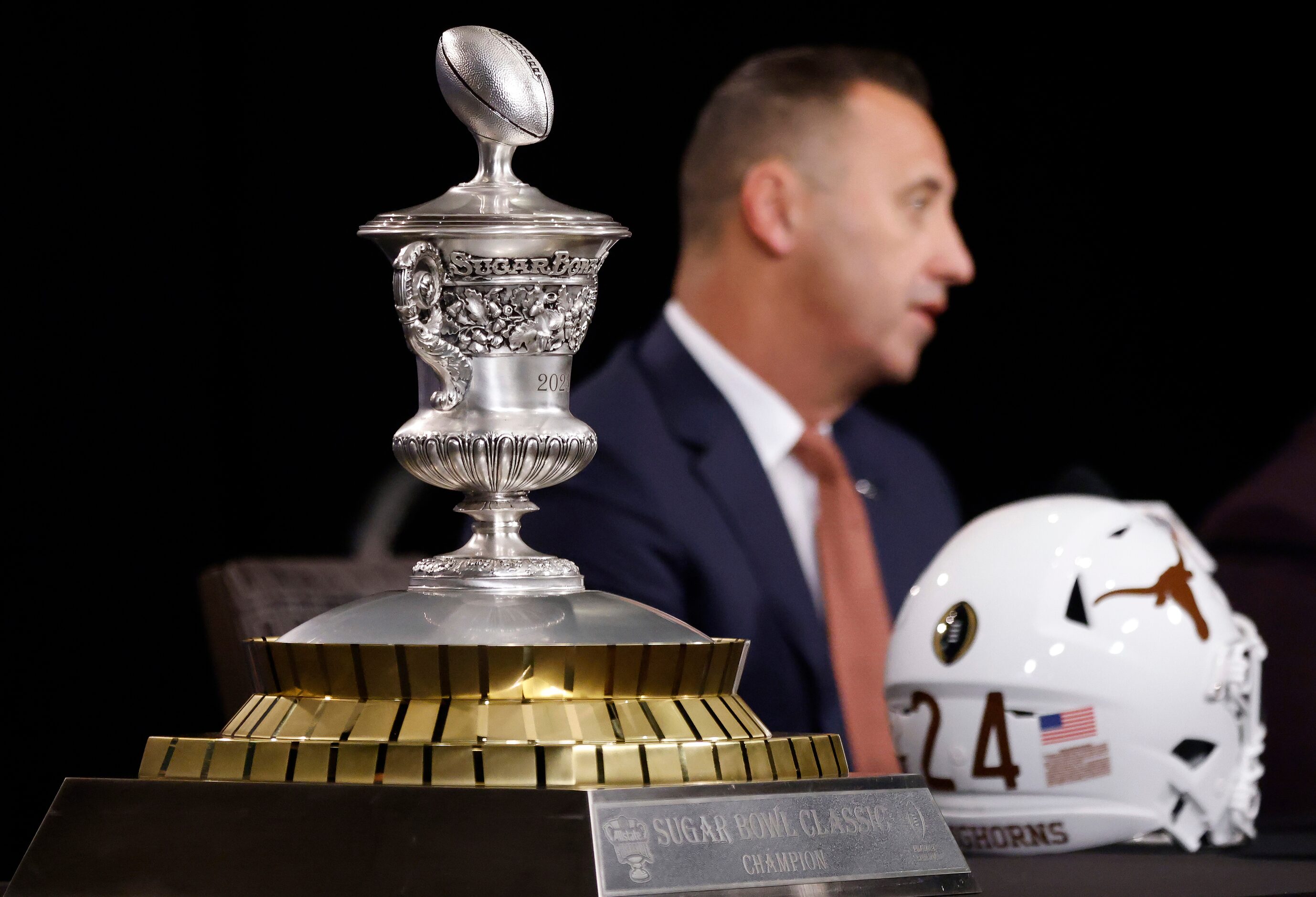 Texas head coach Steve Sarkisian answers questions from the media behind the Sugar Bowl...