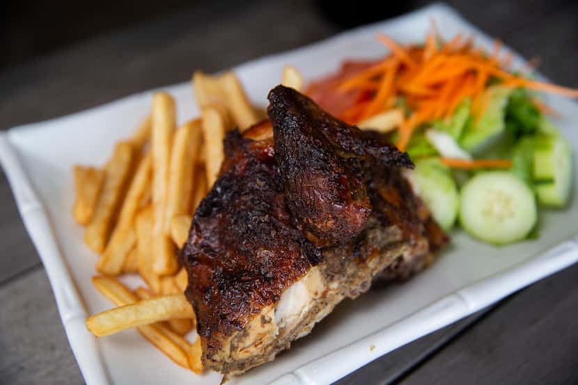 The pollo a la brasa (Peruvian roasted chicken) is served with a side salad and french fries...
