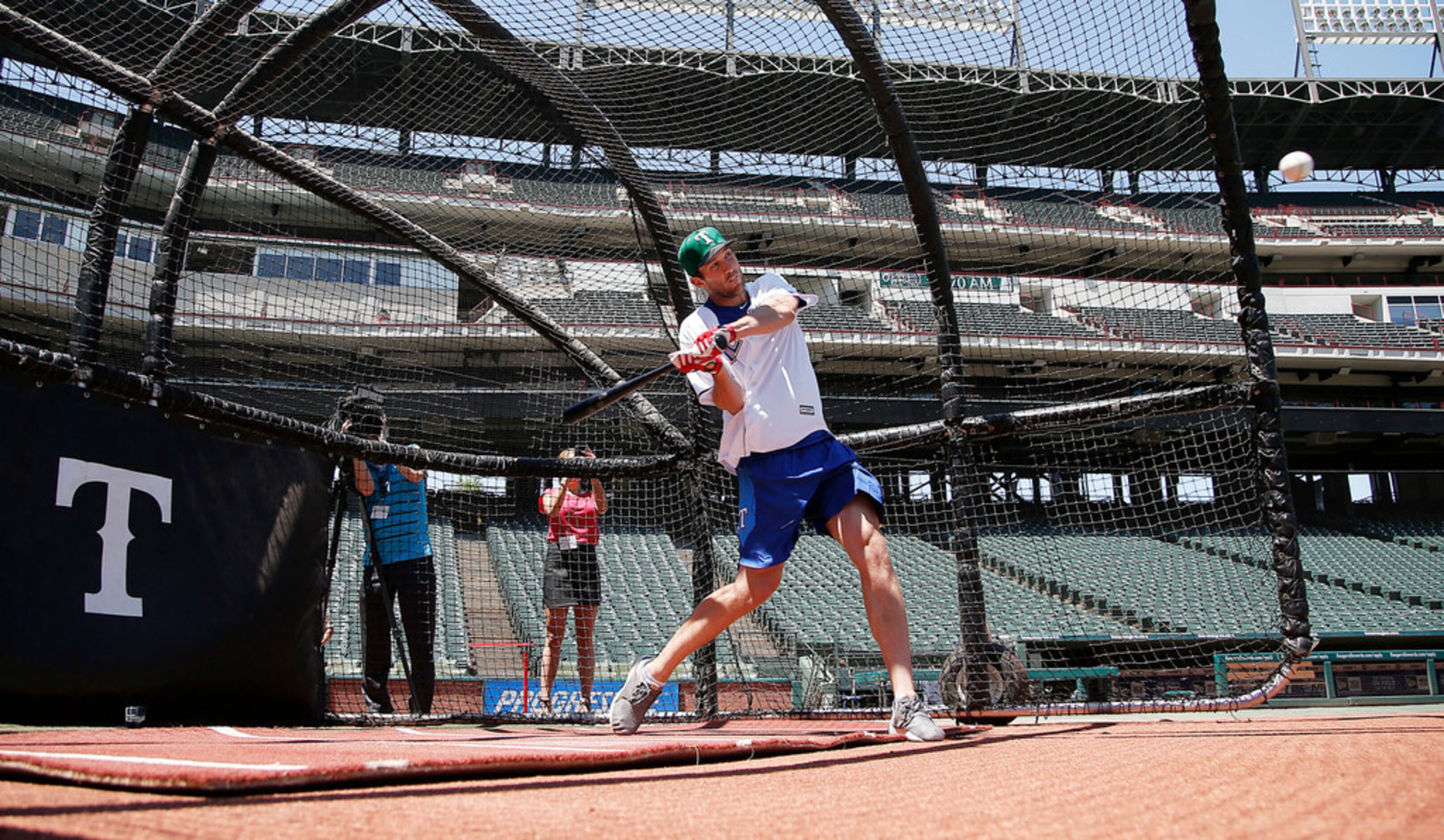 Dallas Stars goalie Ben Bishop swings at a pitch during a batting practice with the Texas...