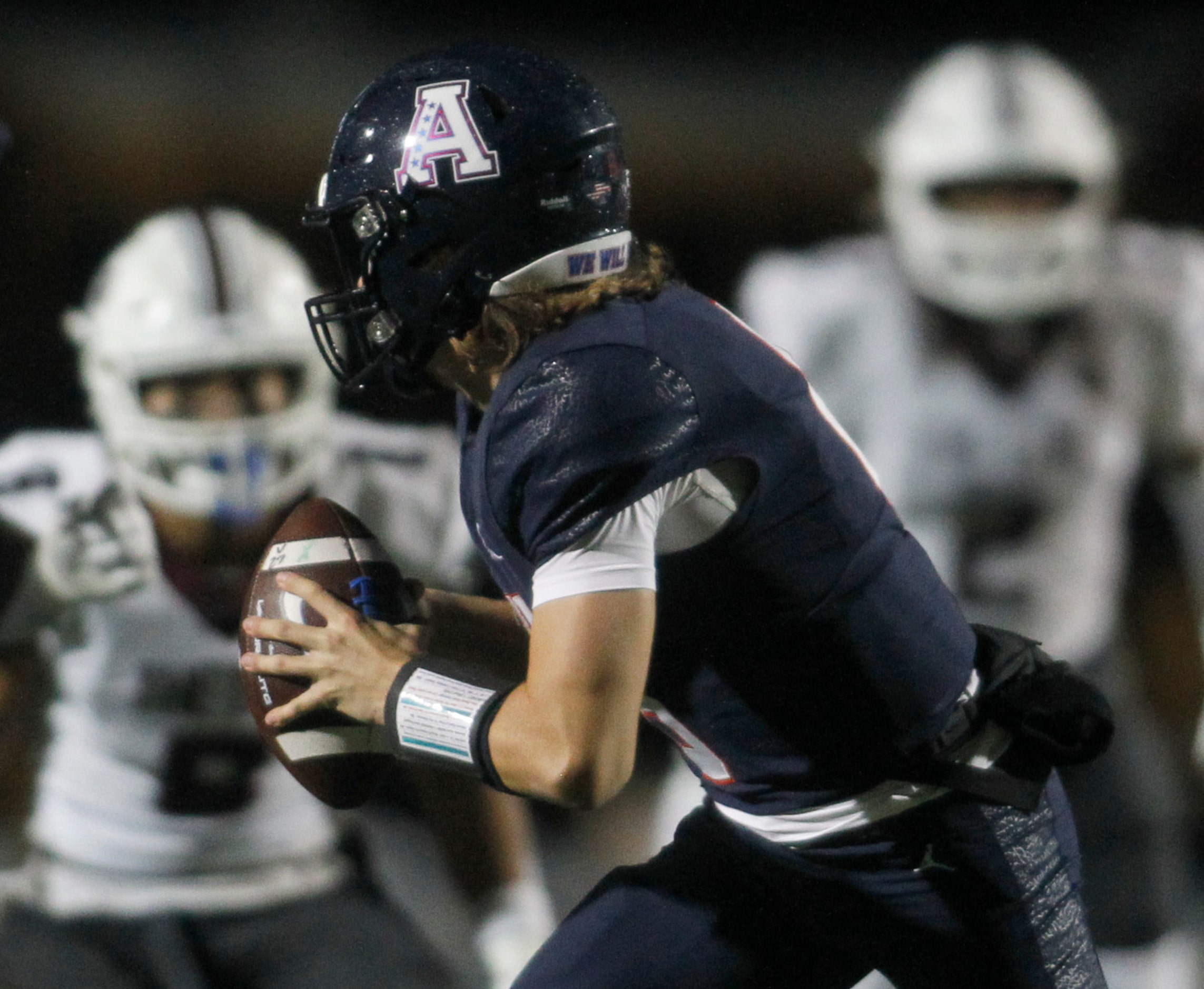 Allen quarterback Dylan Chapman (6) rolls out to avoid the pursuit of Allen defenders during...