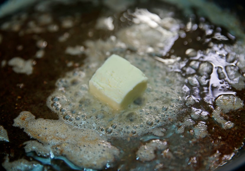 Butter melts in a large cast-iron pan