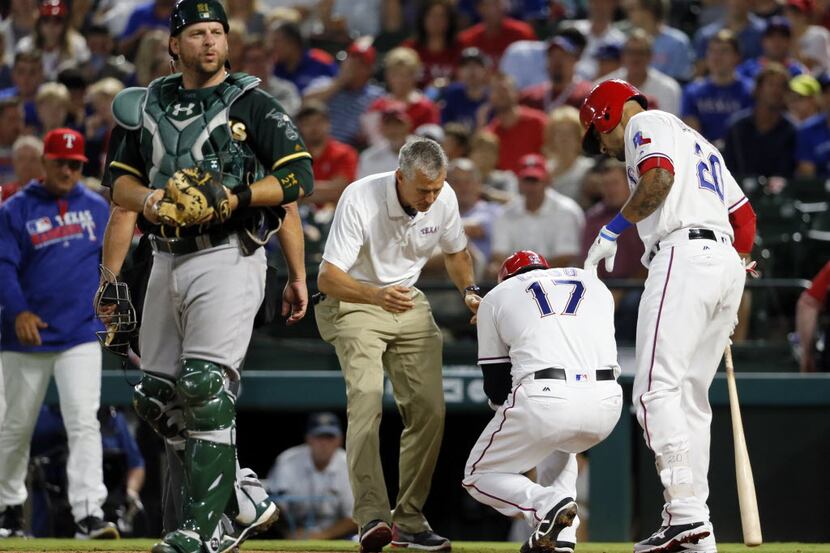 Oakland Athletics catcher Stephen Vogt walks away from the plate as Texas Rangers athletic...