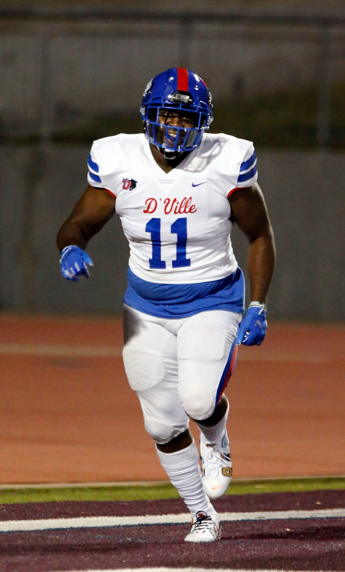 Duncanville’s Tyler Quinn (11) is happy after taking a interception to the end zone for a...