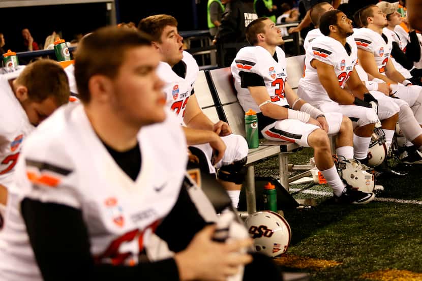 Oklahoma State Cowboys watch the clock run out on the bench in the last thirty seconds of...