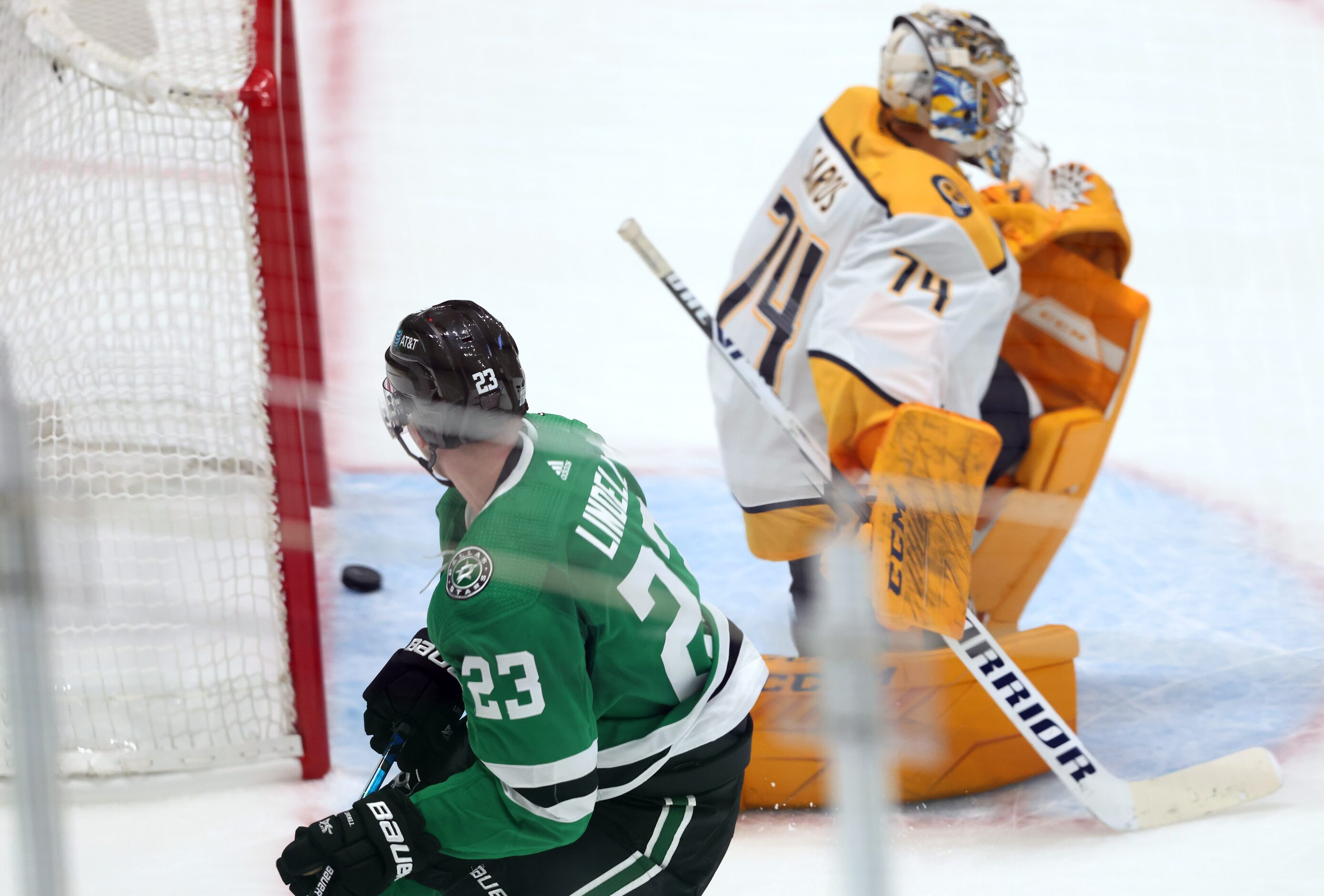 Dallas Stars defenseman Esa Lindell (23) watches his shot pass Nashville Predators...