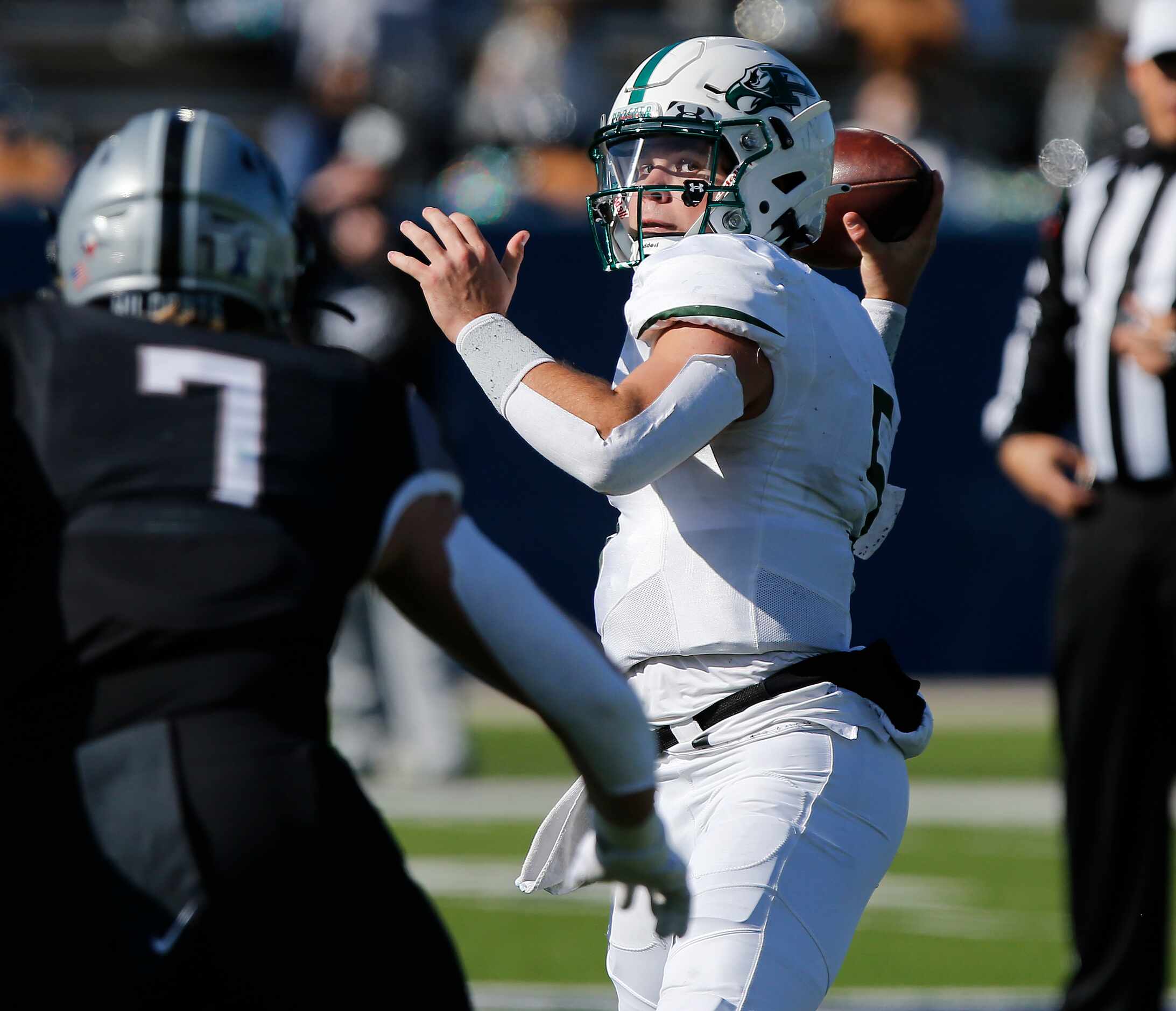 Prosper High School quarterback Jackson Berry (5) throws a pass under pressure from Denton...