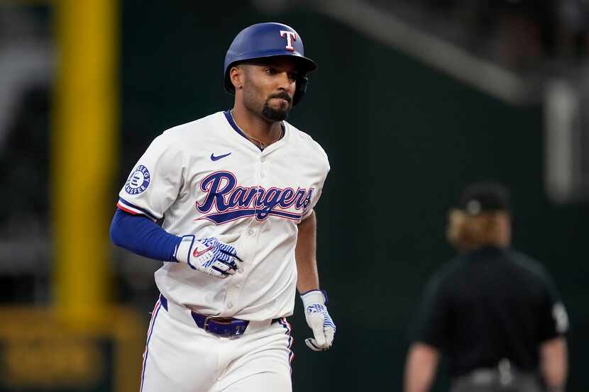 Texas Rangers' Marcus Semien rounds the bases after hitting a two-run home run against the...