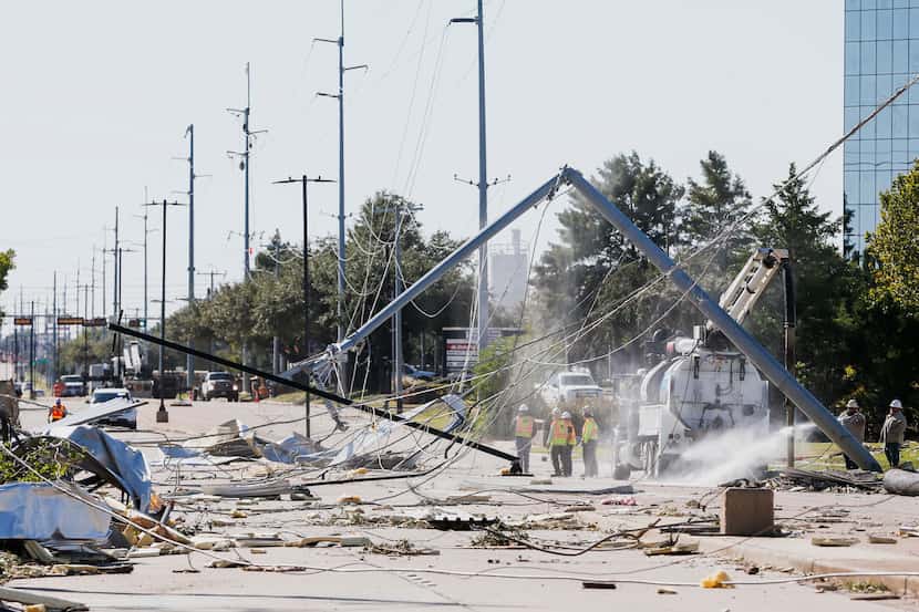 Power crews work along South Shiloh Road in Garland, Texas, on Monday, Oct. 21, 2019 after a...