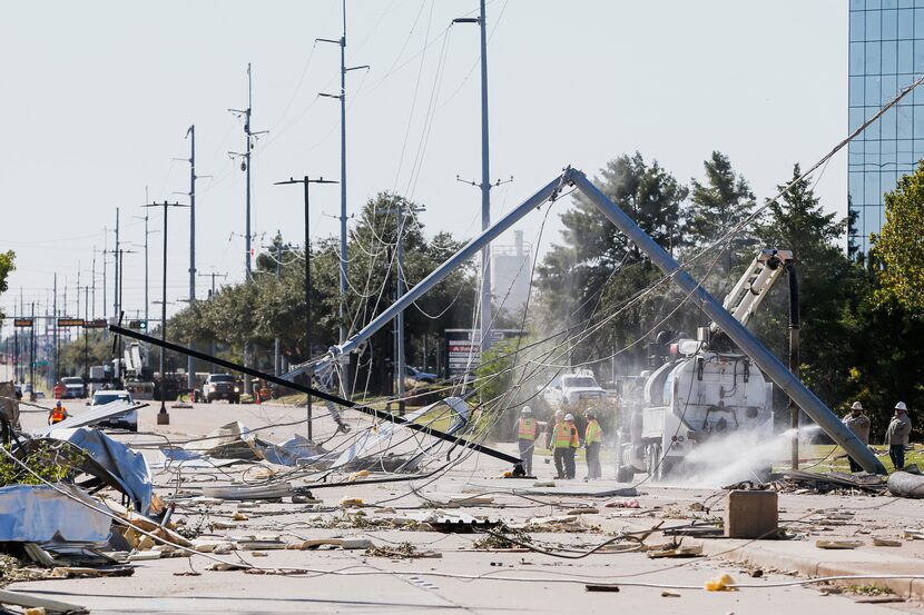 Power crews work along South Shiloh Road in Garland, Texas, on Monday, Oct. 21, 2019 after a...