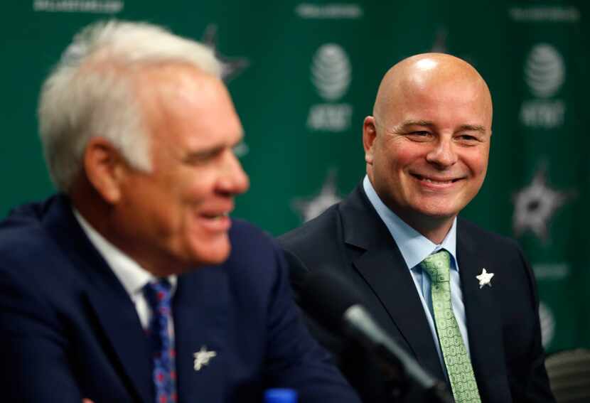 New Dallas Stars head coach Jim Montgomery, right, smiles as Chief Executive Officer Jim...