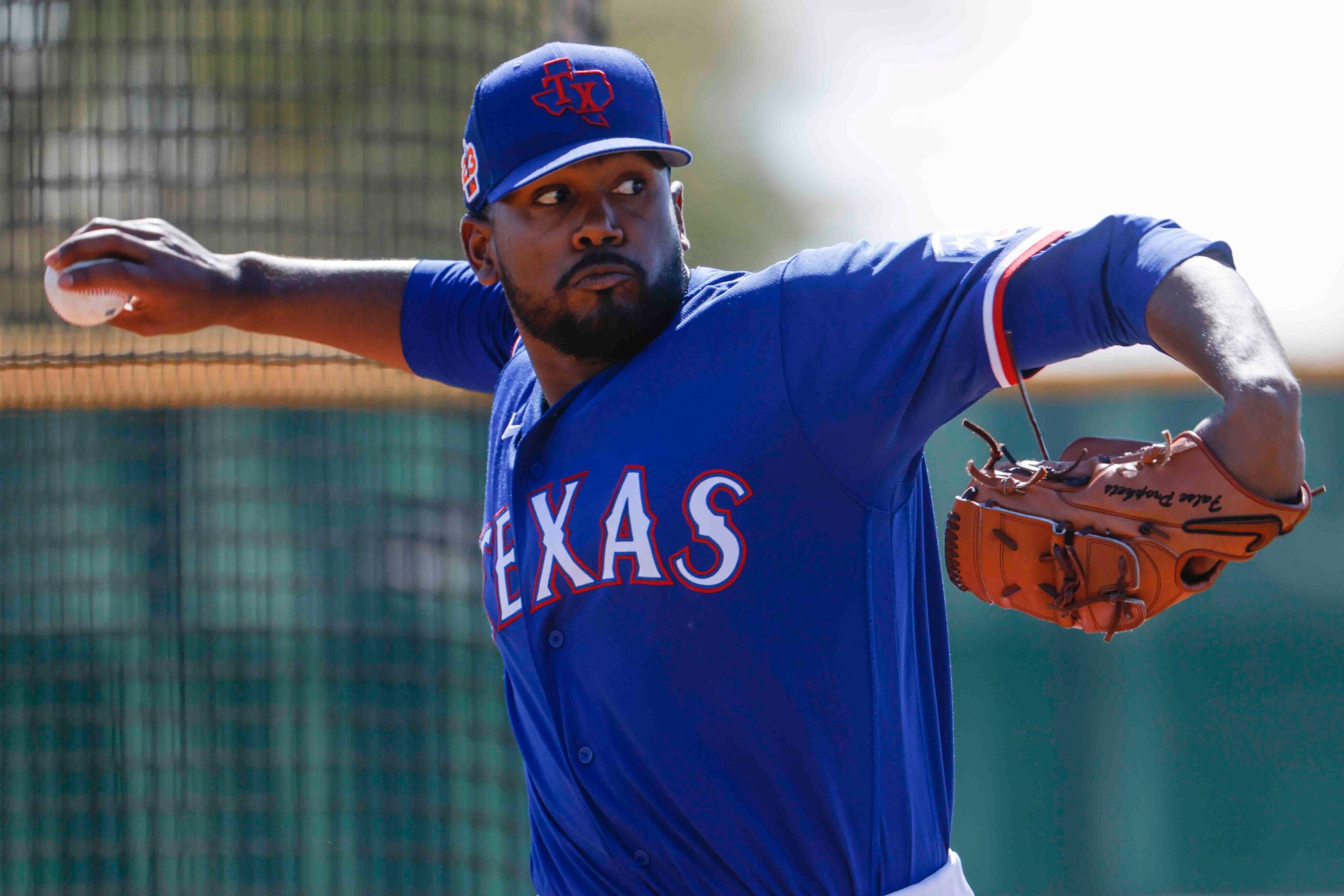 Texas Rangers pitcher Kumar Rocker throws a pitch for batting practice during a spring...