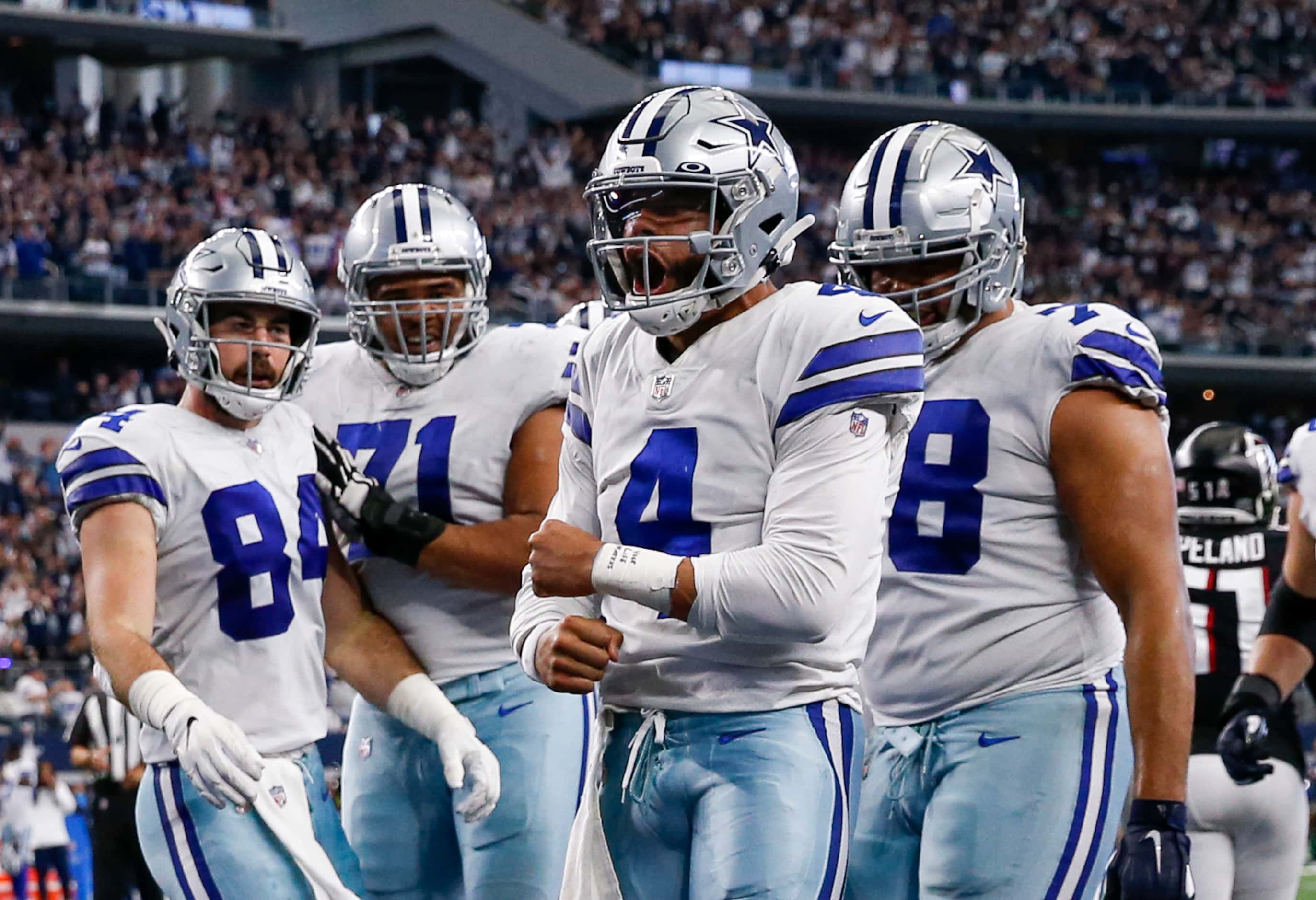 Dallas Cowboys quarterback Dak Prescott (4) celebrates after running for a touchdown with...