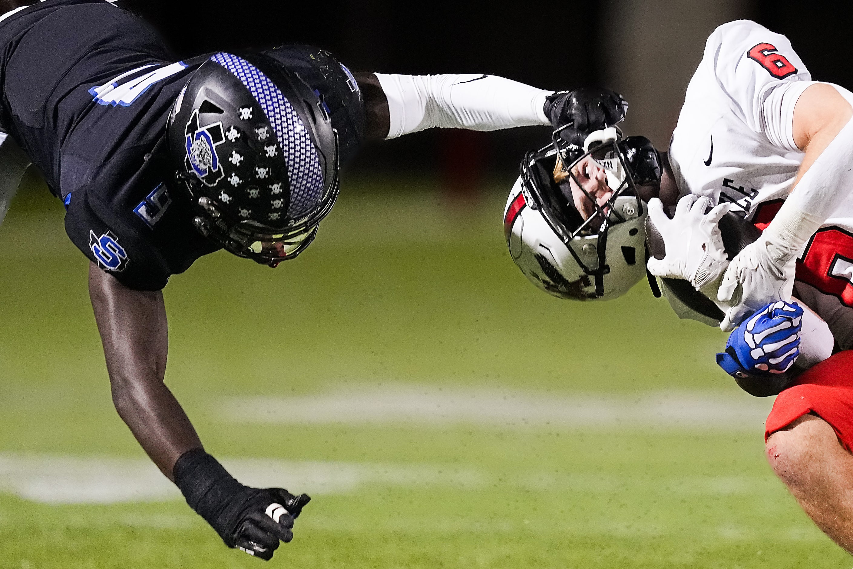 Argyle running back Watson Bell (6) is pulled backwards on a facemask penalty by Mansfield...