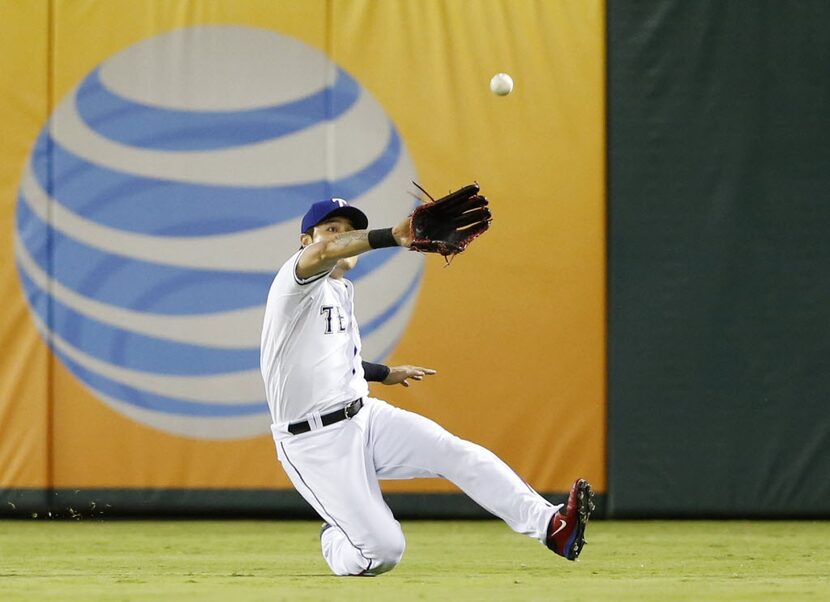 Texas Rangers right fielder Shin-Soo Choo (17) makes a sliding catch off a ball hit by...