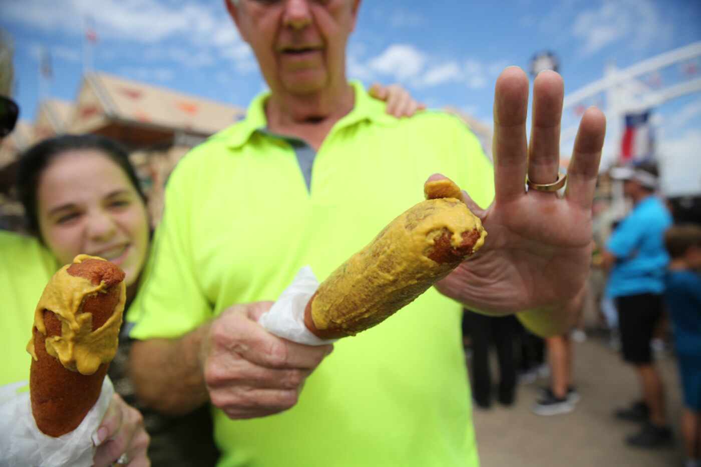 Bud Ainsworth smears mustard onto his Fletcher's corny dog at the State Fair of Texas at...
