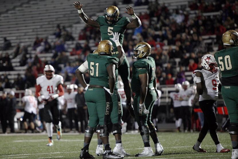 DeSoto senior quarterback Tristen Wallace (5) leaps in the air while celebrating a touchdown...