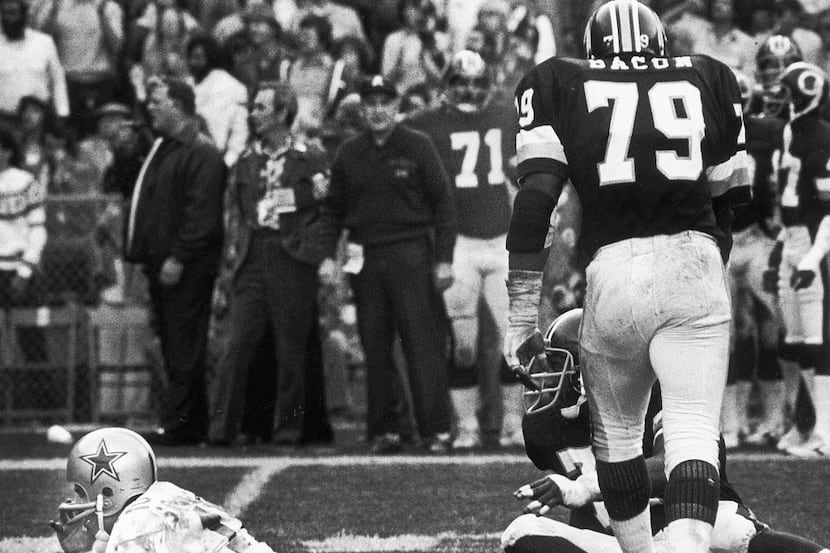 1979 -- Roger Staubach is knocked to the ground against the Washington Redskins.