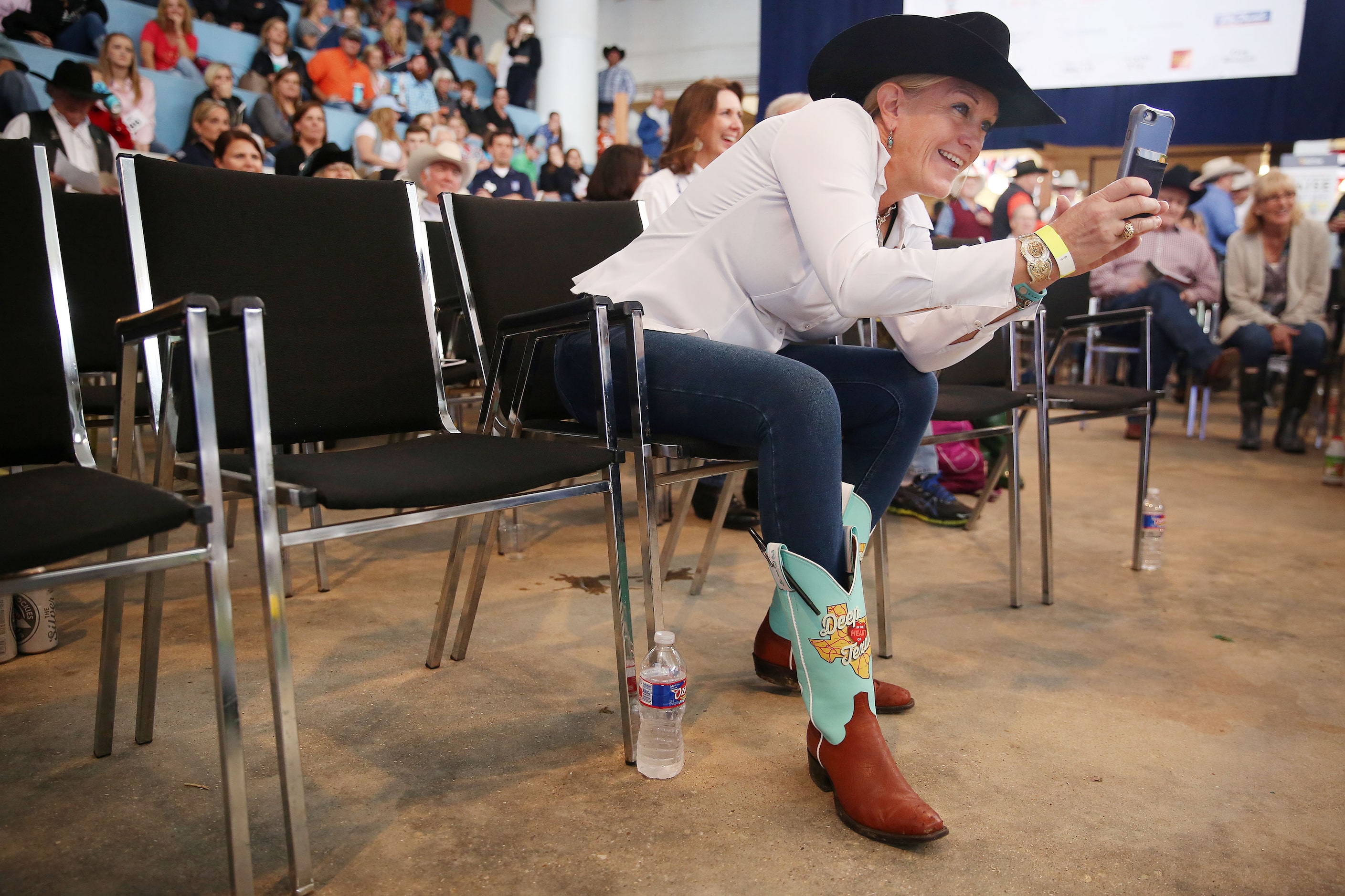 Lisa O'Dwyer, of Dallas, takes a photograph of Ella Rea, 10, with her champion lamb and...