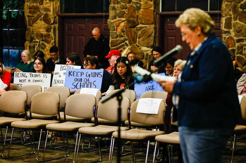 A group of Keller ISD students hold signs against the proposal that stated employees could...