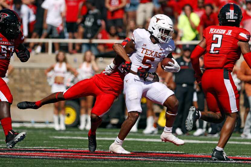 Texas' Bijan Robinson (5) is tackled by Texas Tech's Dadrion Taylor-Demerson (25) during the...
