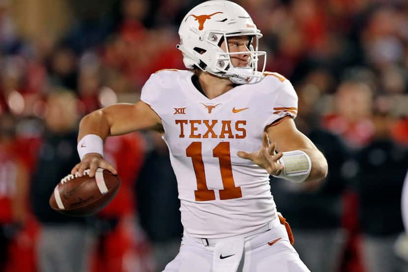 Texas' Sam Ehlinger (11) looks to pass the ball during the first half of an NCAA college...