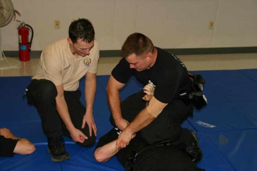 
Mesquite Instructor Clint Crabtree works with recruit Richard Andersen during the police...