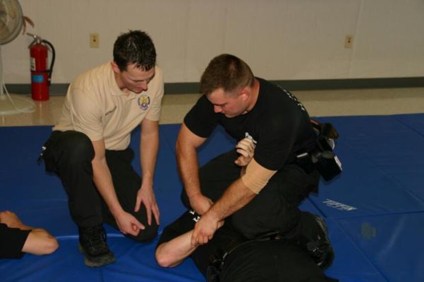 
Mesquite Instructor Clint Crabtree works with recruit Richard Andersen during the police...