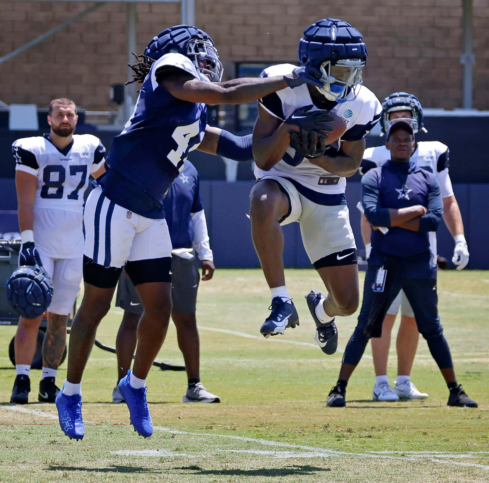 Dallas Cowboys wide receiver Kelvin Harmon (84) pulls in a pass against cornerback Caelen...