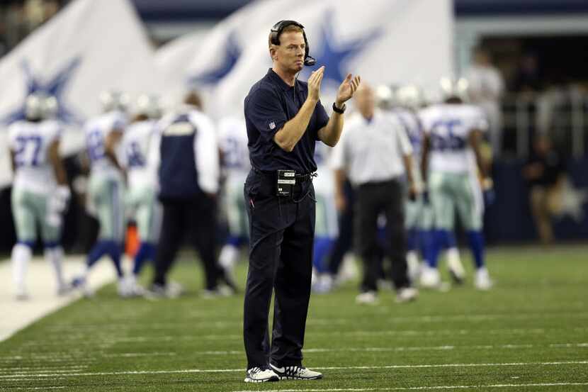 Dallas Cowboys head coach Jason Garrett applauded after a score from his team in a game...
