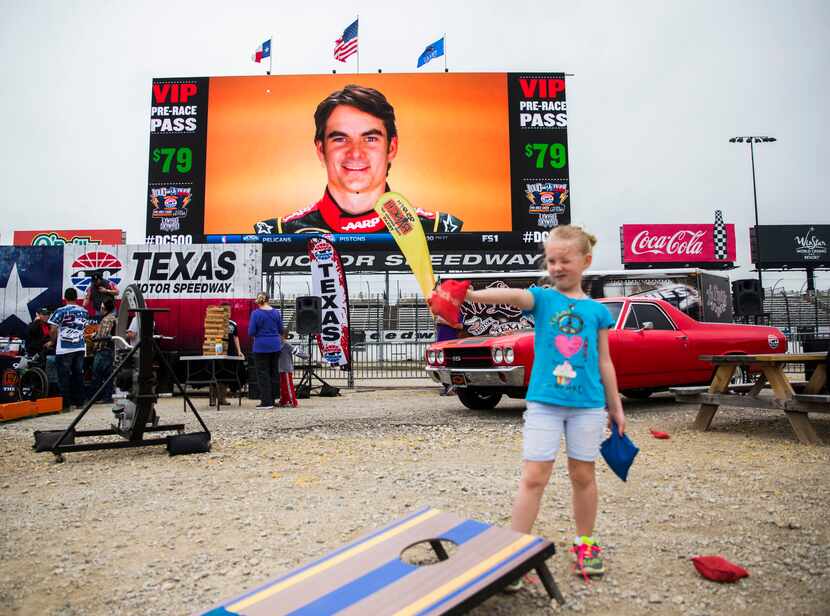 A photo of NASCAR driver Jeff Gordon is broadcast on the big screen in the infield while Zoe...