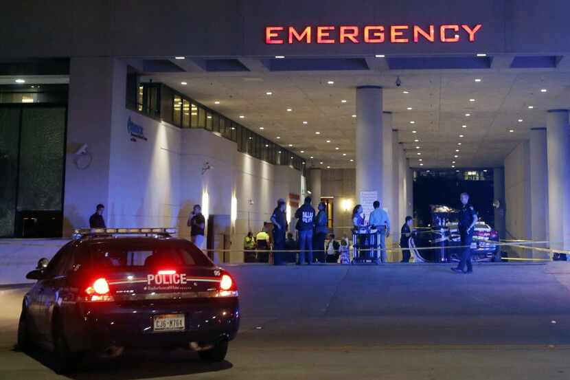 Law enforcement officers stood outside the emergency room at Baylor University Medical...