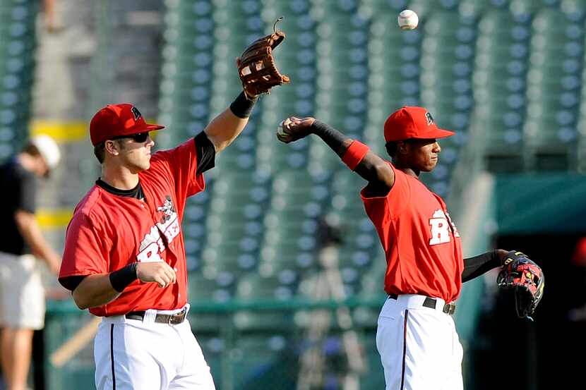 Jurickson Profar, right, and Mike Olt warm up before the minor league baseball game between...