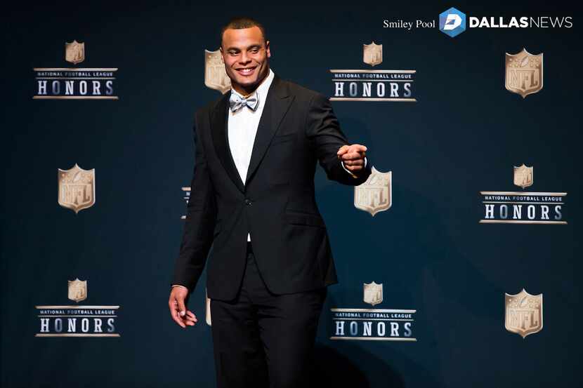 Dallas Cowboys quarterback Dak Prescott waves to people in the audience as he takes the...