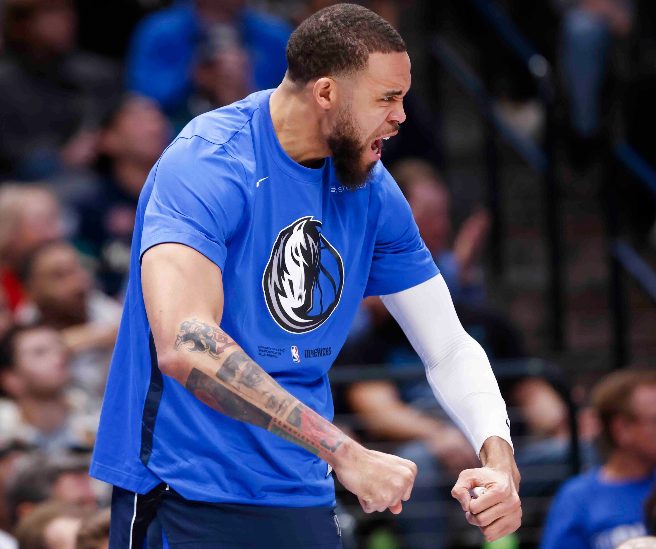 Dallas Mavericks center JaVale McGee (00) cheers from the bench during the second half of an...