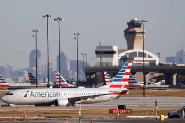 An American Airlines plane makes its way towards the runway before taking off at DFW...