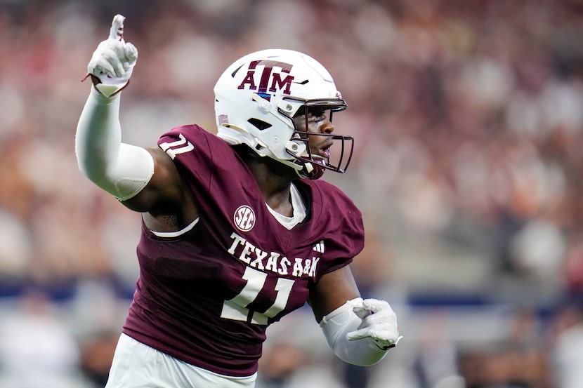 Texas A&M defensive lineman Nic Scourton gestures during the first half of an NCAA college...