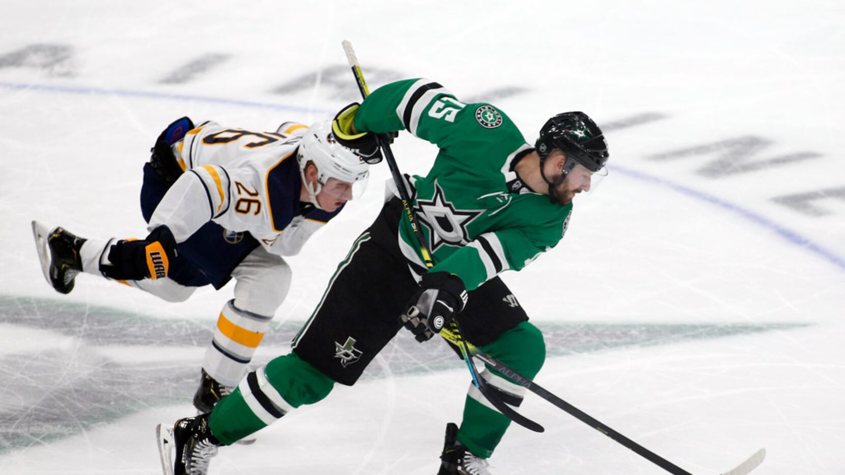 Buffalo Sabres defenseman Rasmus Dahlin, left, is called for the hooking penally as he takes...