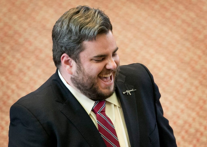  Rep. Jonathan Stickland, wearing a gun lapel pin, smiles during debate of HB 910, an open...