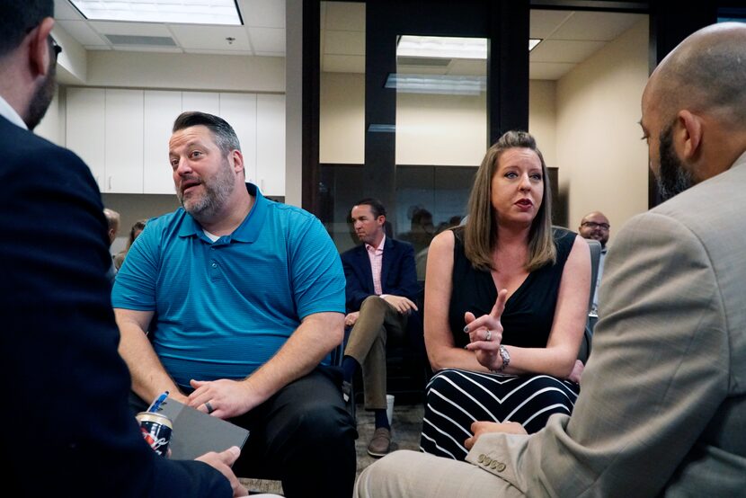 Jerod Smith and Kelly Elliott do a sales exercise with coworkers during a morning sales...