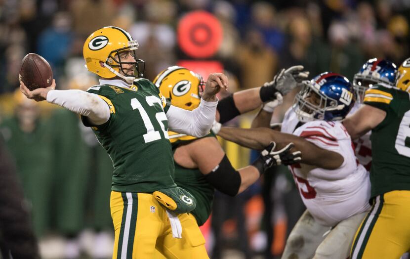 Green Bay Packers quarterback Aaron Rodgers throws in the second half of a wild card playoff...