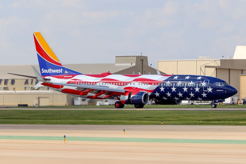 A Southwest Airlines Boeing 737-800 named “Freedom One” taxis to the gate at Dallas Love...