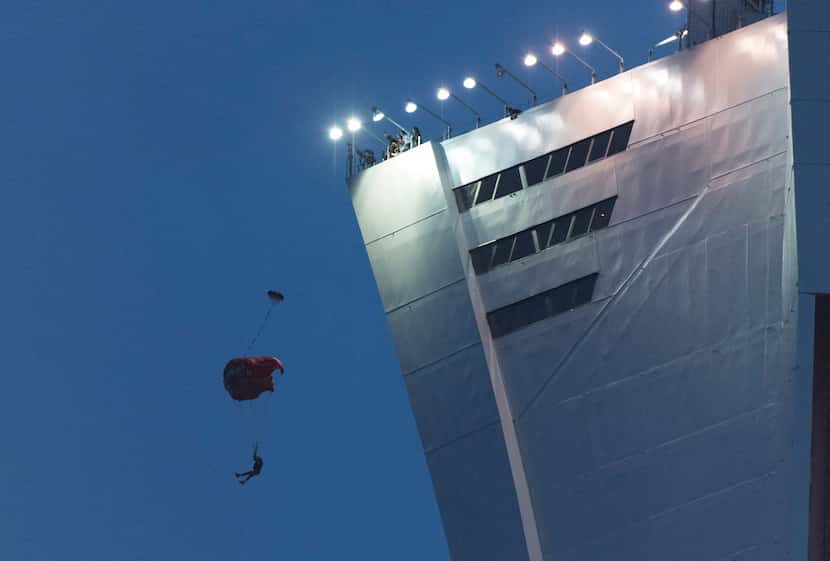 A person parachutes off Olympic Stadium during an MLS soccer match between the Montreal...