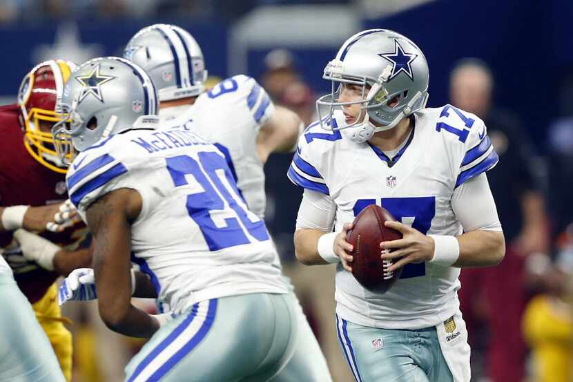 Dallas Cowboys quarterback Kellen Moore (17) rolls out to pass against the Washington...