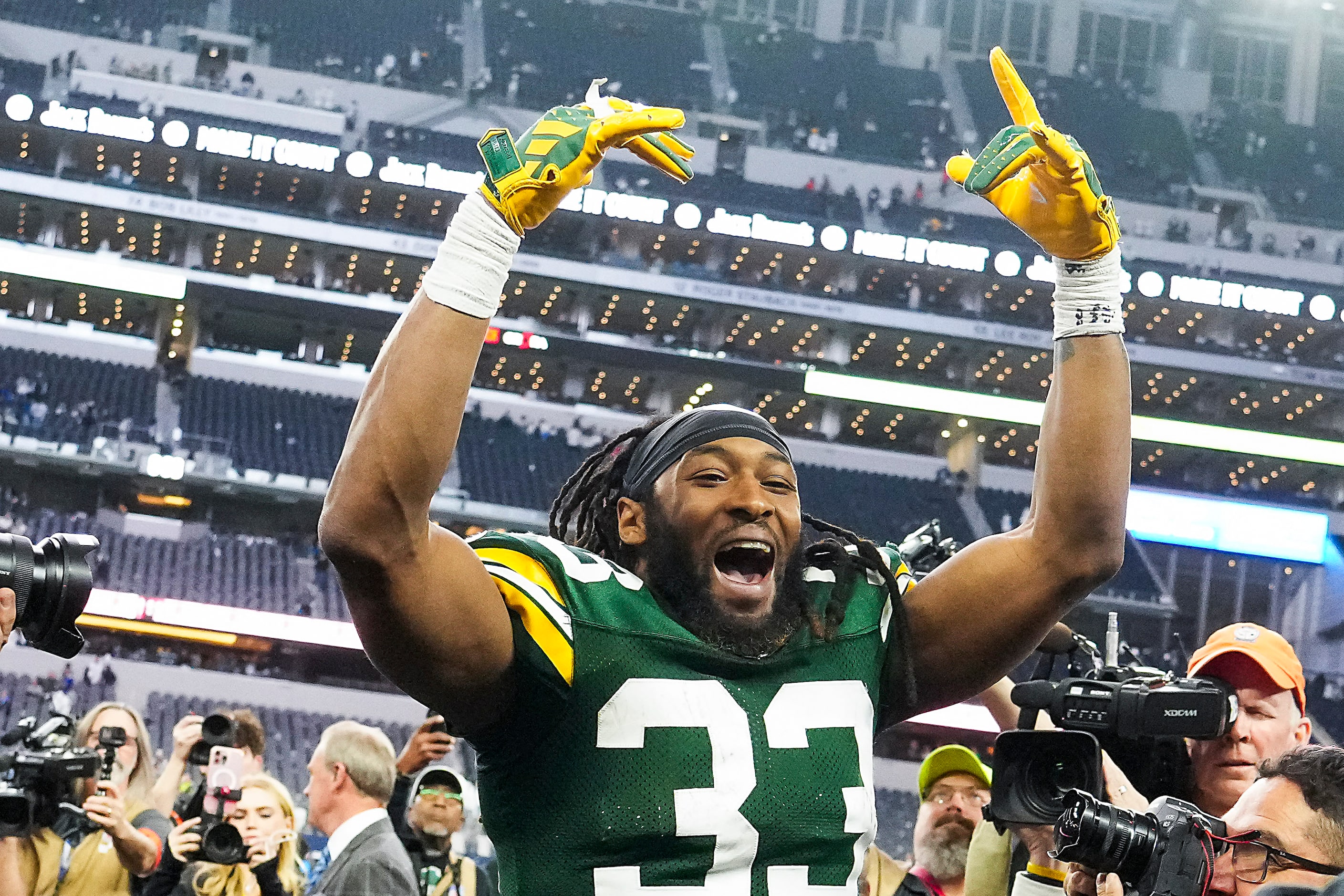 Green Bay Packers running back Aaron Jones (33) celebrates as he leaves the field after a...