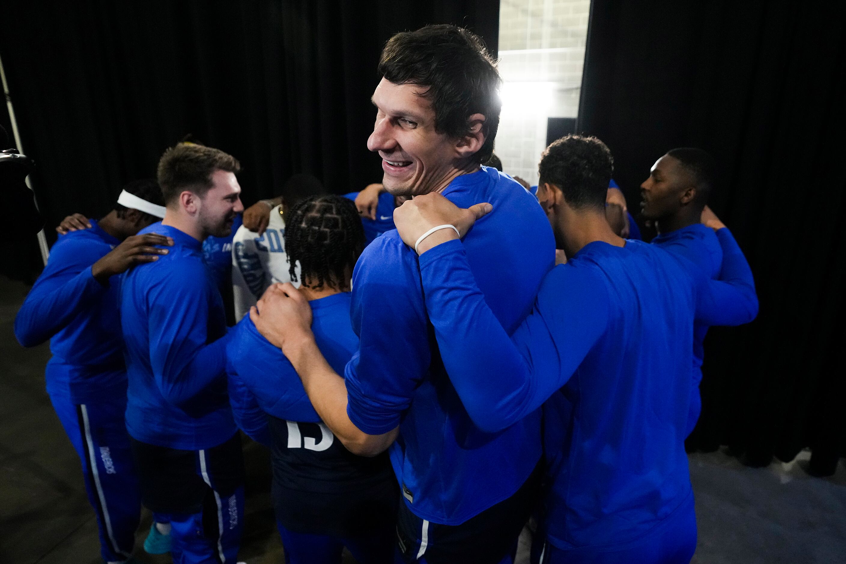 Dallas Mavericks center Boban Marjanovic smiles as the team huddles before Game 2 of the NBA...