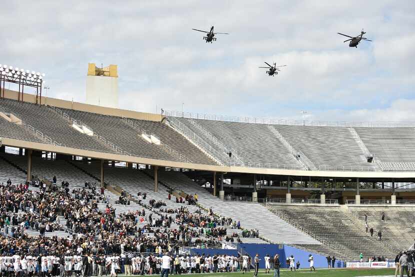 Helicopters fly over the Cotton Bowl before the start of the Heart of Dallas Bowl on...